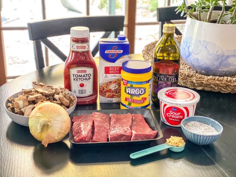 Beef stroganoff ingredients include steak, ketchup, beef broth, sour cream, onion, mushrooms, garlic, and corn starch