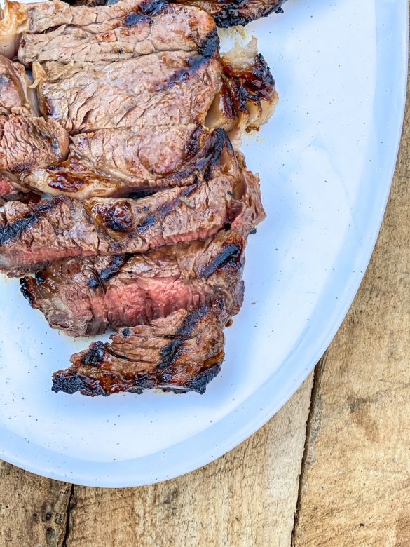 Sliced ribeye steak on a plate. 