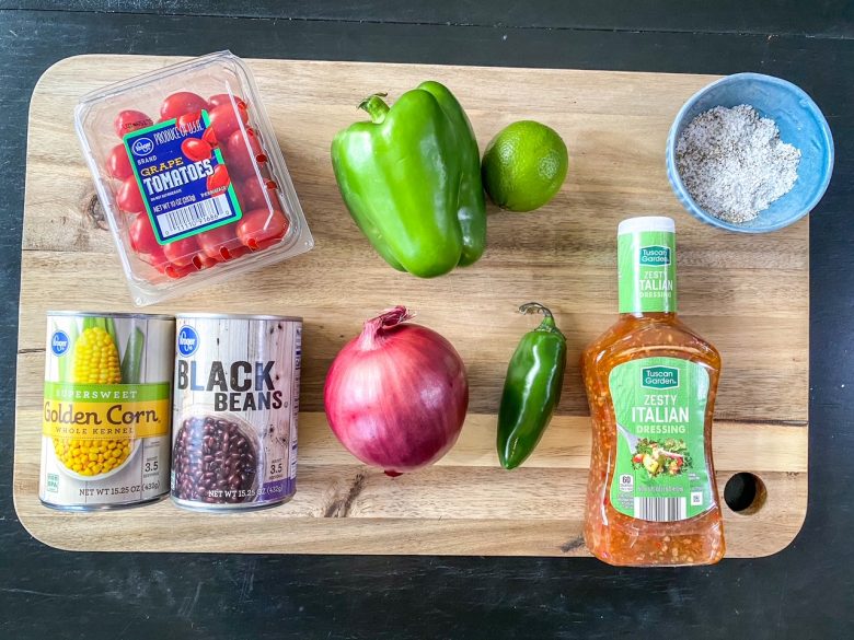 Ingredients inclue grape tomatoes, green pepper, italian dressing, red onion, jalapeno, lime, black beans, corn, salt and pepper. 