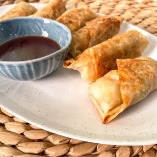 Homemade eggrolls with sweet and sour sauce.