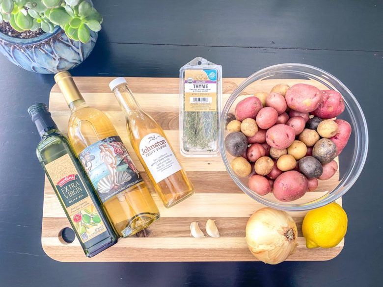 Lemon potato salad ingredients: lemon, onion, garlic, thyme, white wine, olive oil, apple cider vinegar, potatoes. 