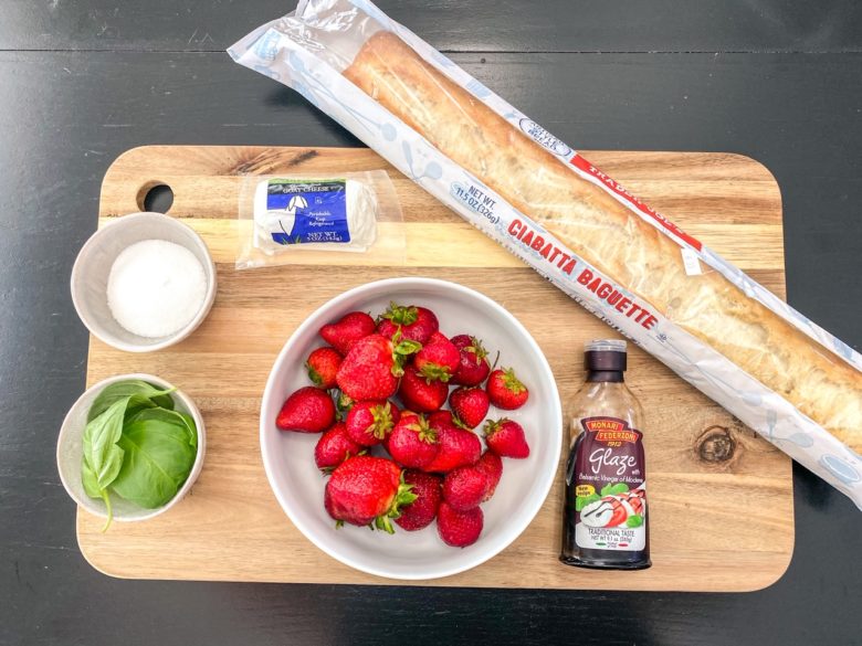 Strawberry bruschetta ingredients: basil, strawberries, goat cheese, sugar, French bread, balsamic glaze. 