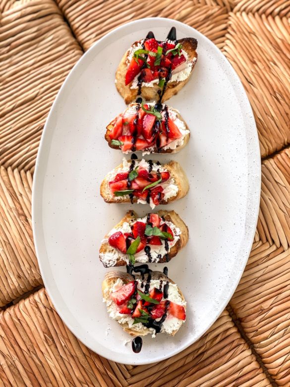Strawberry & Goat Cheese Bruschetta on a plate with balsamic drizzle. 