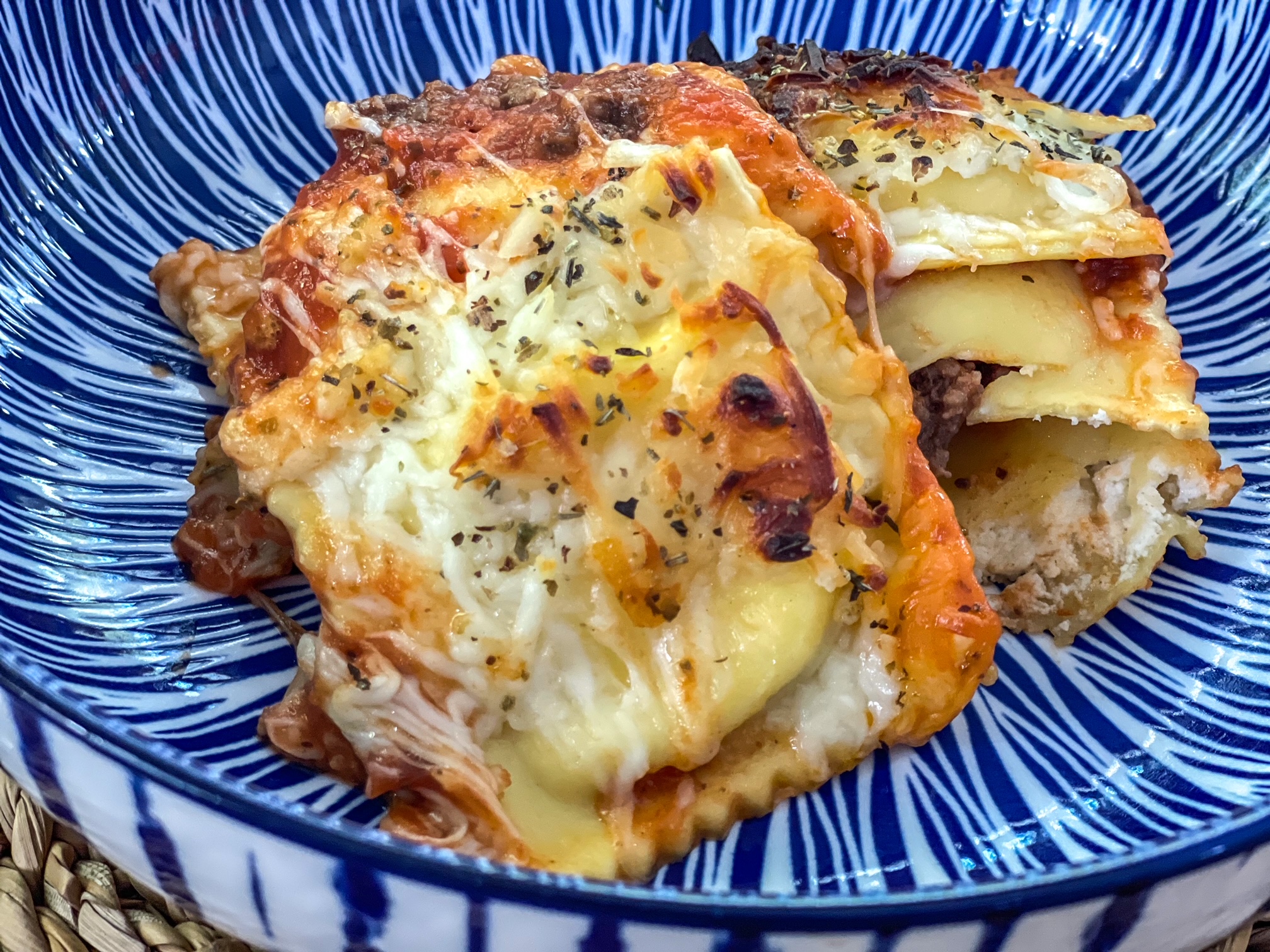 Cheesy ravioli lasagna bake in a bowl. 